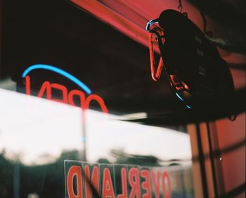 Low angle view of text on illuminated sign at night