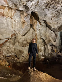 Rear view of man standing against rock formations