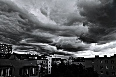 Low angle view of buildings against cloudy sky