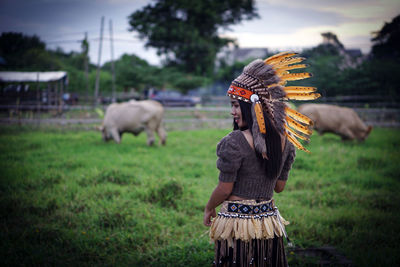 Tribal costume and his cow