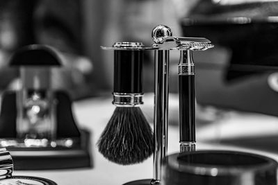 Close-up of shaving equipment on table