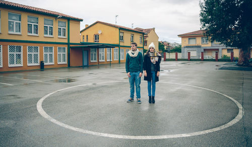 Full length of man standing on road in city