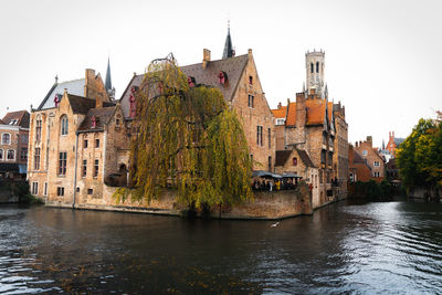 River amidst buildings against sky in city