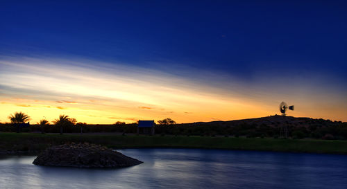 Scenic view of lake against sky during sunset