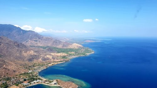 High angle view of sea and mountains against sky