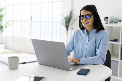 Young woman using laptop on table