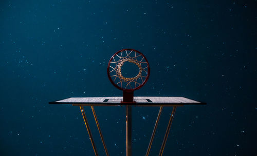 Directly below view of basketball hoop against constellation in sky