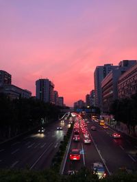 Traffic on city street during sunset