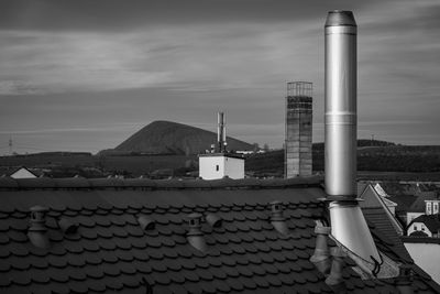 Roof of building by sea against sky