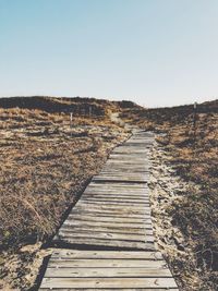 Boardwalk against clear sky