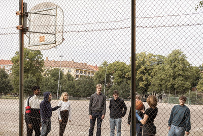 Teenagers playing basketball