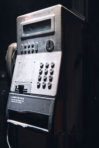 Close-up of an old telephone in the outskirts of the city