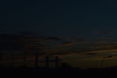 Silhouette trees against sky at night