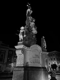 Low angle view of statue at night