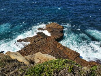 High angle view of rocks on shore at sea