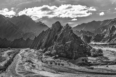 Scenic view of mountain range against cloudy sky