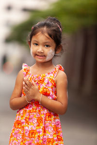 Portrait of smiling girl standing outdoors