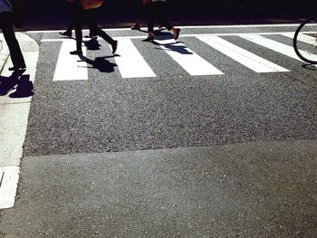 Low section of people walking on road