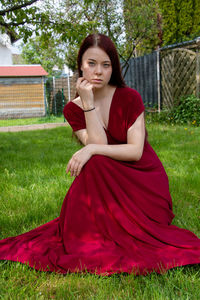 Portrait of young woman sitting on grass