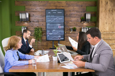 Side view of business colleagues working at office