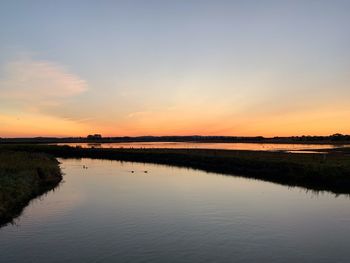 Scenic view of lake against sky during sunset