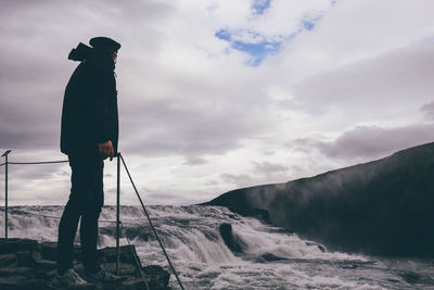 Male tourist looking at gullfoss fall