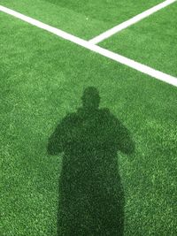 Shadow of man on soccer field