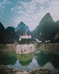 Scenic view of lake and mountains against sky