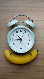 Close-up of clock on wooden table