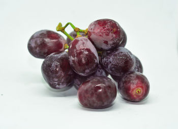 Close-up of grapes over white background