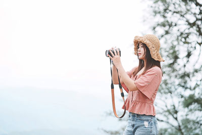 Woman holding umbrella standing outdoors