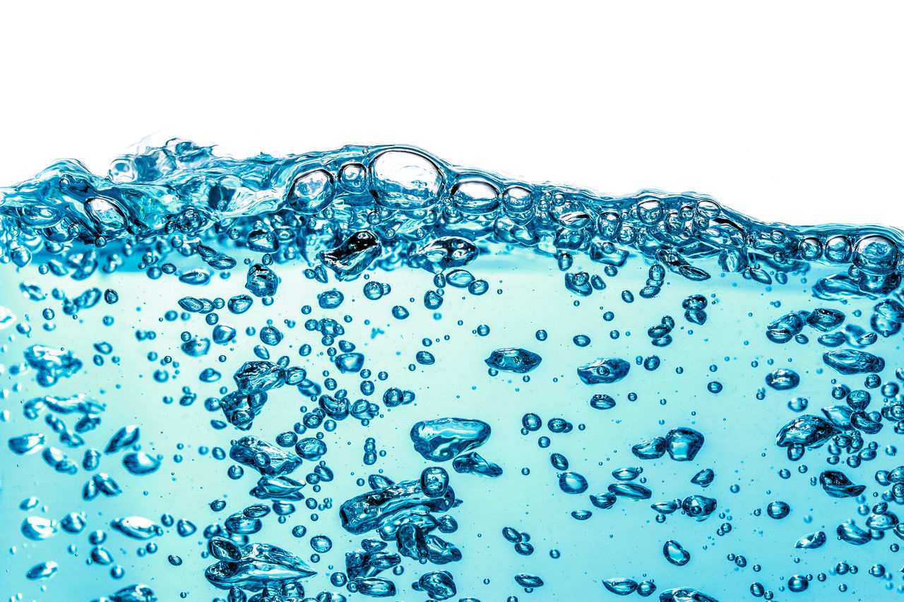 CLOSE-UP OF BUBBLES AGAINST BLUE BACKGROUND