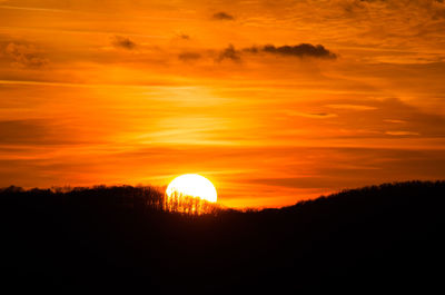 Scenic view of silhouette landscape against romantic sky at sunset