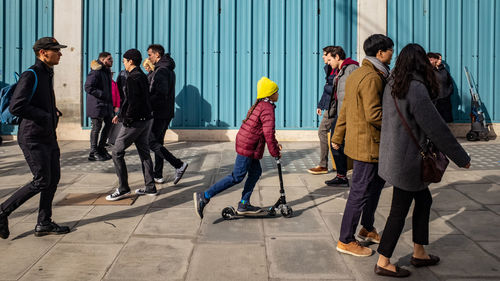 Group of people on footpath in city