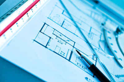 Close-up of pen and ruler on blueprint