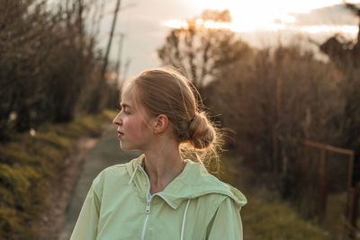 Side view of young woman standing outdoors