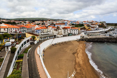 High angle view of road by buildings against sky