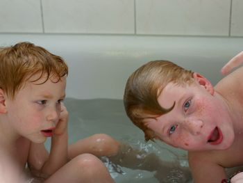 Close-up of boys in bathtub