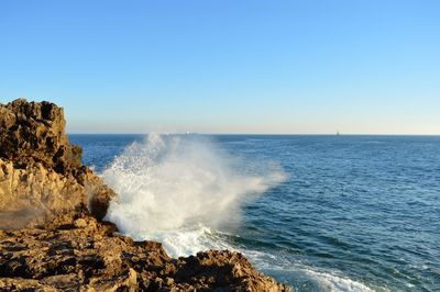 Scenic view of sea against clear blue sky