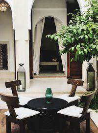 Empty chairs and table in building