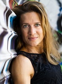 Portrait of smiling mature woman with gray eyes by shutter