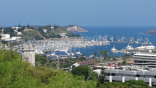 High angle view of town by sea against clear sky