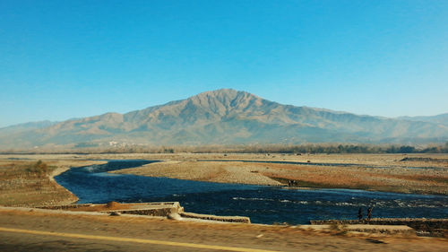 Scenic view of mountains against clear blue sky