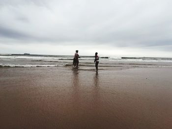 People on beach against sky. the sand, sky and the sea blend , nature is a wander.