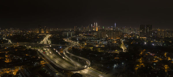 High angle view of city lit up at night