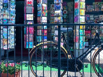 View of multi colored postcards, shop, old bicycle on a terrasse