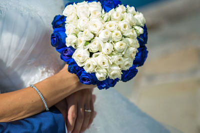 Midsection of woman holding bouquet