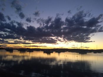 Scenic view of lake against sky at sunset