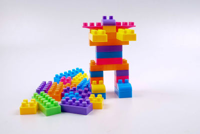 Stack of colorful toys against white background