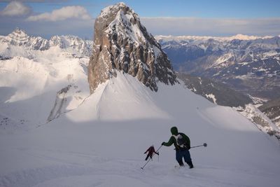 People skiing on snowcapped mountain